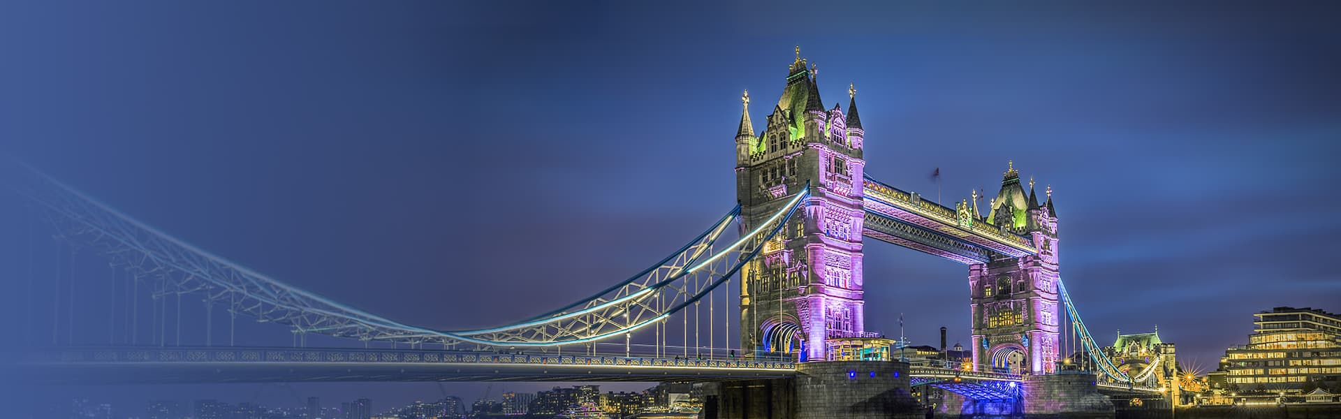 Tower Bridge at dusk with illuminated London skyline